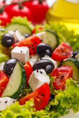 Greek salad on a white acrylic background