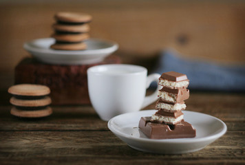 chocolate in a plate, milk in a mug, cookies