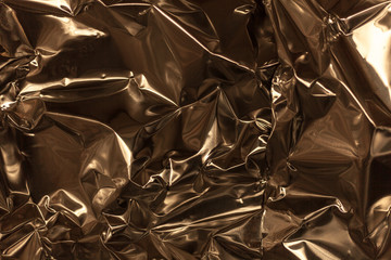 Full frame take of a sheeT of crumpled gold aluminum foil