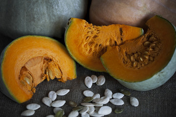 Still life with pumpkin on emerald background in rustic style. Selective focus. Closeup