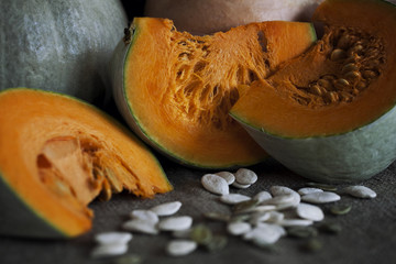 Still life with pumpkin on emerald background in rustic style. Selective focus. Closeup