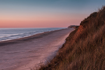 Fototapeta na wymiar Coastline panorama view with endless beaches and giant grass sand dunes at the northern danish sea. Løkken in North Jutland in Denmark, Skagerrak, North Sea