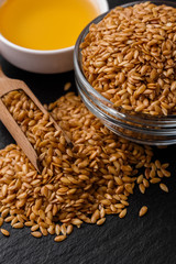 seeds of golden flax on a dark stone background