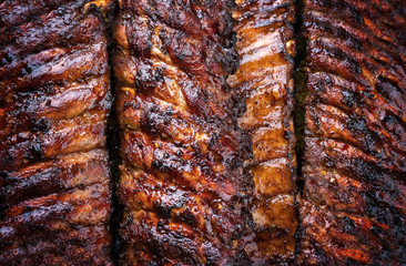 Barbecue spare ribs St Louis cut with hot honey chili marinade as top view copy space and food texture