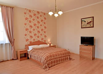  A bedroom interior in pink tones with a picture on a wall. Modern classics