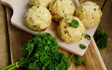 Homemade Fresh Bread dumpling.(German name is Semmelknödel)
European food with wooden board and parsley.
