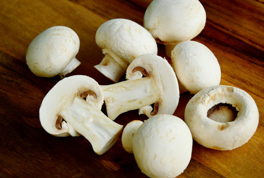 Agaricus bisporus or portobello mushroom on wooden floor.