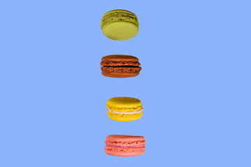 Stack of the french macaroons isolated on a blue background