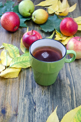 autumn leaves and red apples and a Cup of coffee 