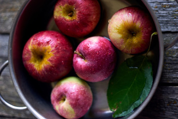 fresh ripe apples in a pot of water