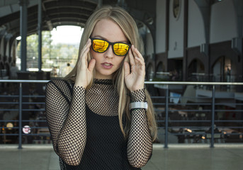 Sunglasses. Street fashion concept - close up portrait of a pretty blonde girl.