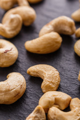 cashew nuts on a dark stone background