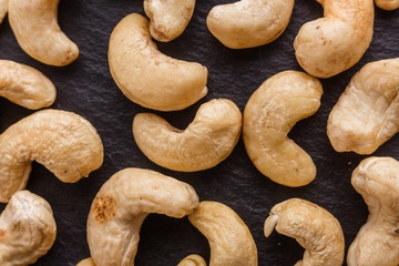 cashew nuts on a dark stone background