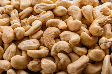 cashew nuts on a dark stone background