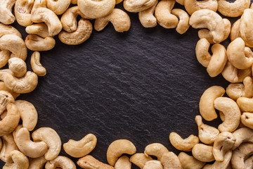 cashew nuts on a dark stone background
