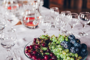 Buffet table with glass of water and fruits