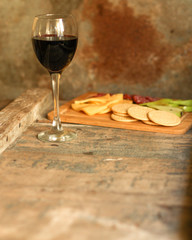 glass of red wine and a bottle on the table (alcohol). Top view. food background copy space