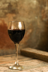 glass of red wine and a bottle on the table (alcohol). Top view. food background copy space