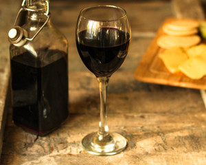glass of red wine and a bottle on the table (alcohol). Top view. food background copy space
