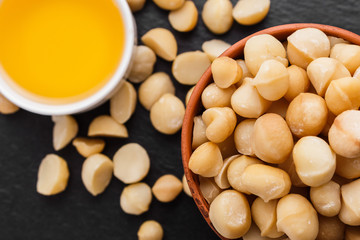 delicious macadamia nuts on a dark stone background