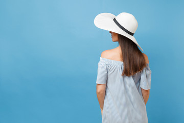Back view portrait of elegant fashion young woman in white summer large wide brim sun hat, dress...