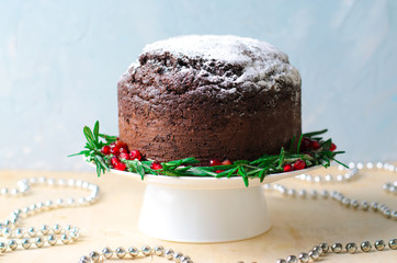 Christmas Cake Decorated with Icing Sugar, Rosemary and Pomegranate