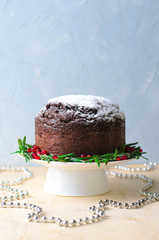 Christmas Cake Decorated with Icing Sugar, Rosemary and Pomegranate