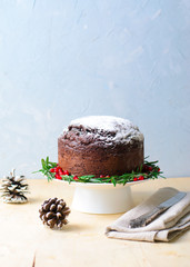 Christmas Cake Decorated with Icing Sugar, Rosemary and Pomegranate