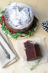 Christmas Cake Decorated with Icing Sugar, Rosemary and Pomegranate