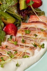 Fried calamari rings with healthy salad and cream sauce