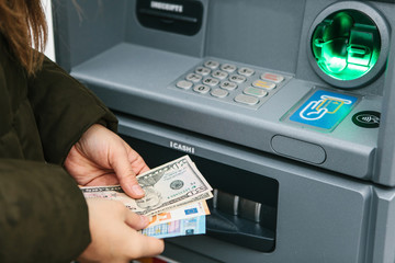 The tourist withdraws money from the ATM for further travel. Finance, credit card, withdrawal of...