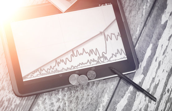 The graph of income growth. Electronic tablet with a graph of gr