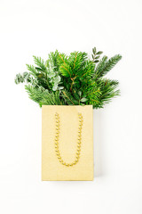 Fir branches in a shopping bag on a white background. Christmas Shopping concept. Flat lay, top view