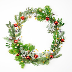 Fototapeta na wymiar Beautiful round frame of fir and pine branches with Christmas decorations white background. Christmas concept. Flat lay, top view