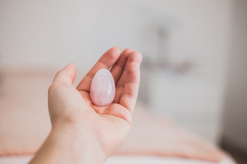 Woman holds yoni egg in hand