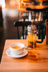 Sea buckthorn tea in french press with honey