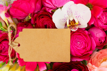 Flowers composition. Floral background made of flowers. Flat lay, top view, copy space on paper tag