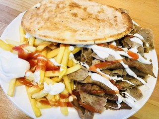 Doner kebab meat with fries and pita bread 