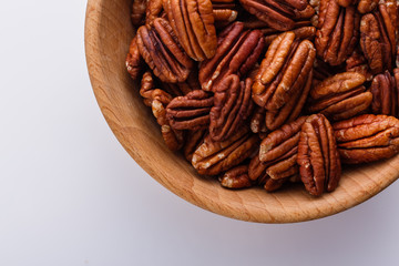 delicious pecan nuts on a white acrylic background
