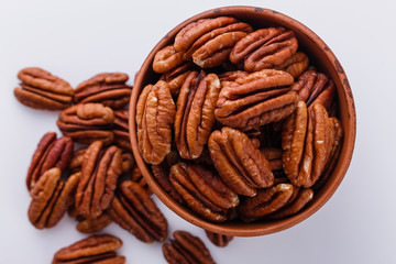 delicious pecan nuts on a white acrylic background