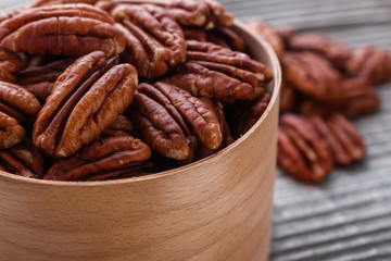 delicious pecan nuts on a rustic wooden background