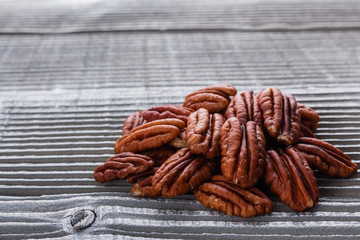 delicious pecan nuts on a rustic wooden background