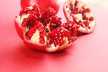 Ripe Pomegranates. sliced and whole pomegranate on a table.