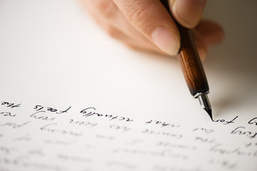 Fototapeta premium Writing letter to a friend. Selective focus and shallow depth of field.