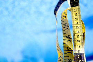 Measuring tape on pool background