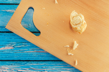 Bread, bun, crumbs scattered on a wooden board