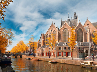 Fototapeta na wymiar Oude Kerk over canal at spring day, Amsterdam at fall, Holland