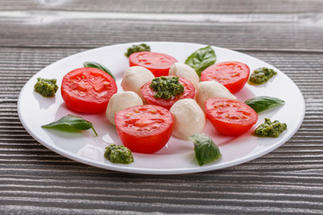 Caprese salad on a wooden rustic background