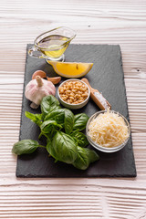Ingredients for pesto sauce on the kitchen board