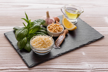 Fototapeta na wymiar Ingredients for pesto sauce on the kitchen board